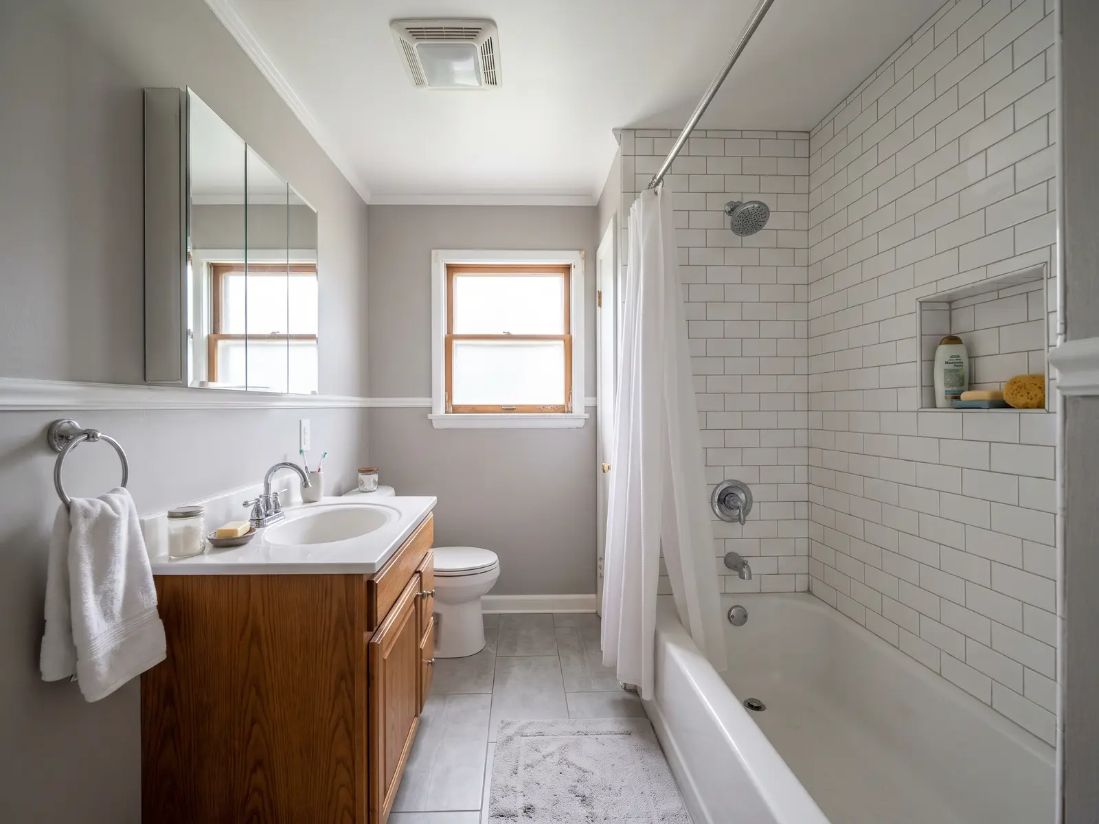 Remodeled bathroom in a Lexington, KY Chevy Chase home with a new tiled shower, white vanity and hexagon floor tile